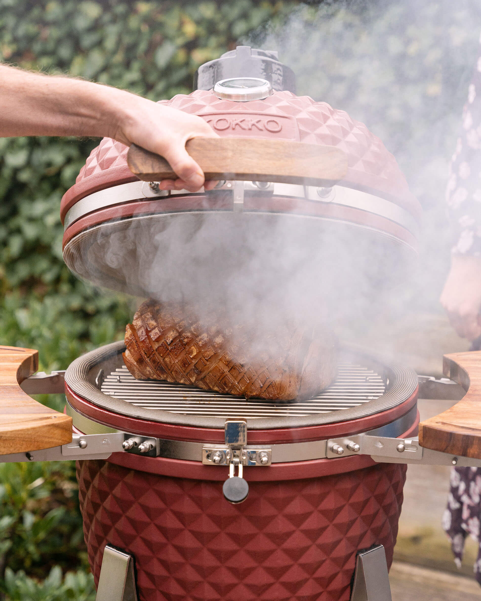 Kamado Kokko L 18 pouces en cours de fumage avec dégagement de fumée.