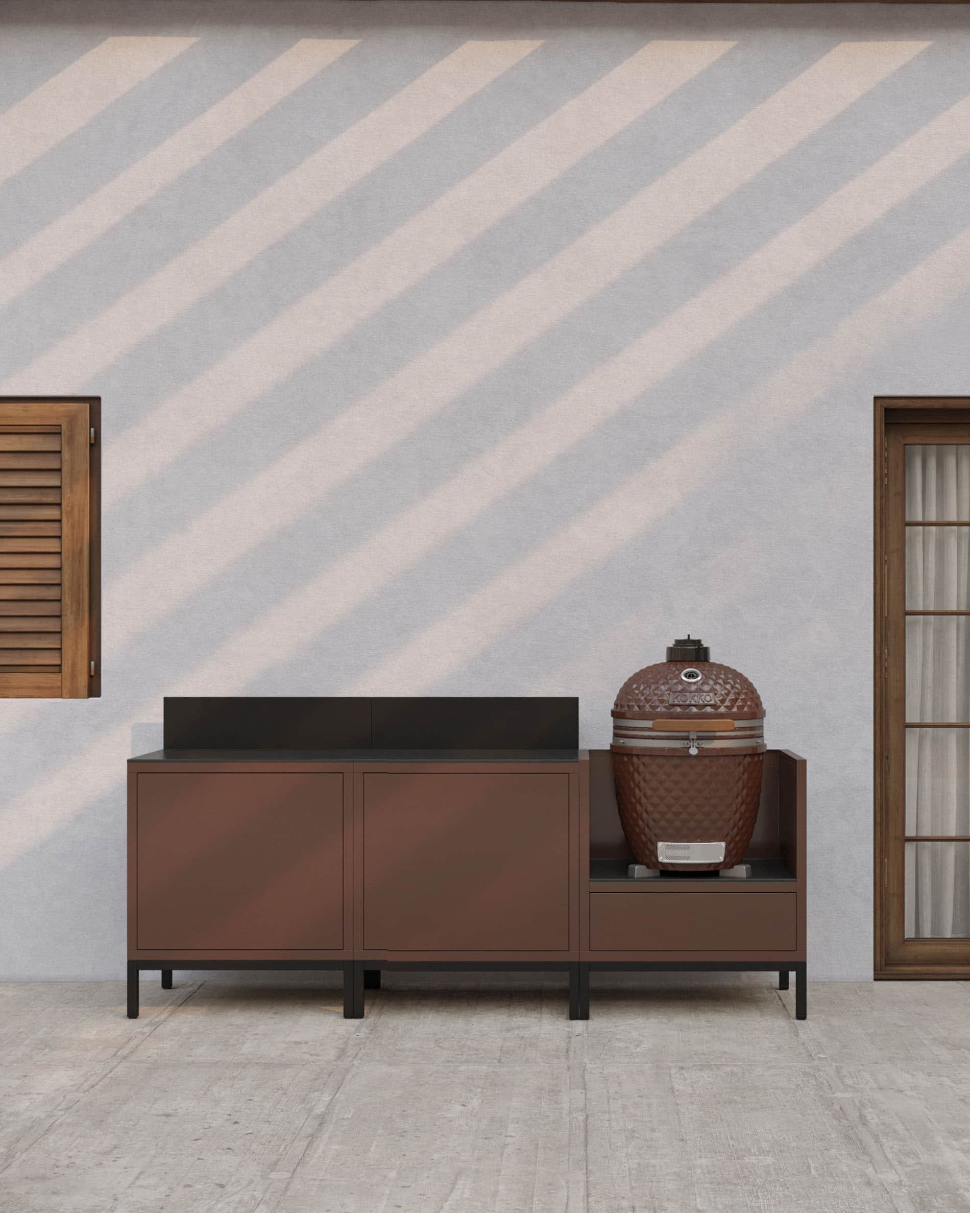 Outdoor-Küche auf Stelzen in Rostfarbe mit dunkler Arbeitsplatte, geschlossenen Stauräumen und einem speziellen Modul für die Integration eines Kamado-Grills.