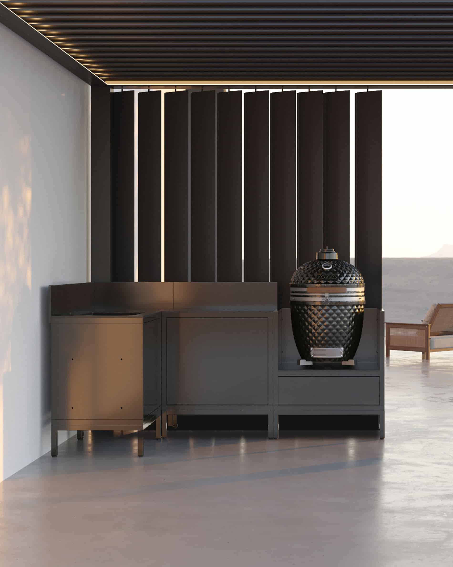 Cuisine pilotis d’angle avec kamado, meubles fermés noirs et plan de travail sous pergola.