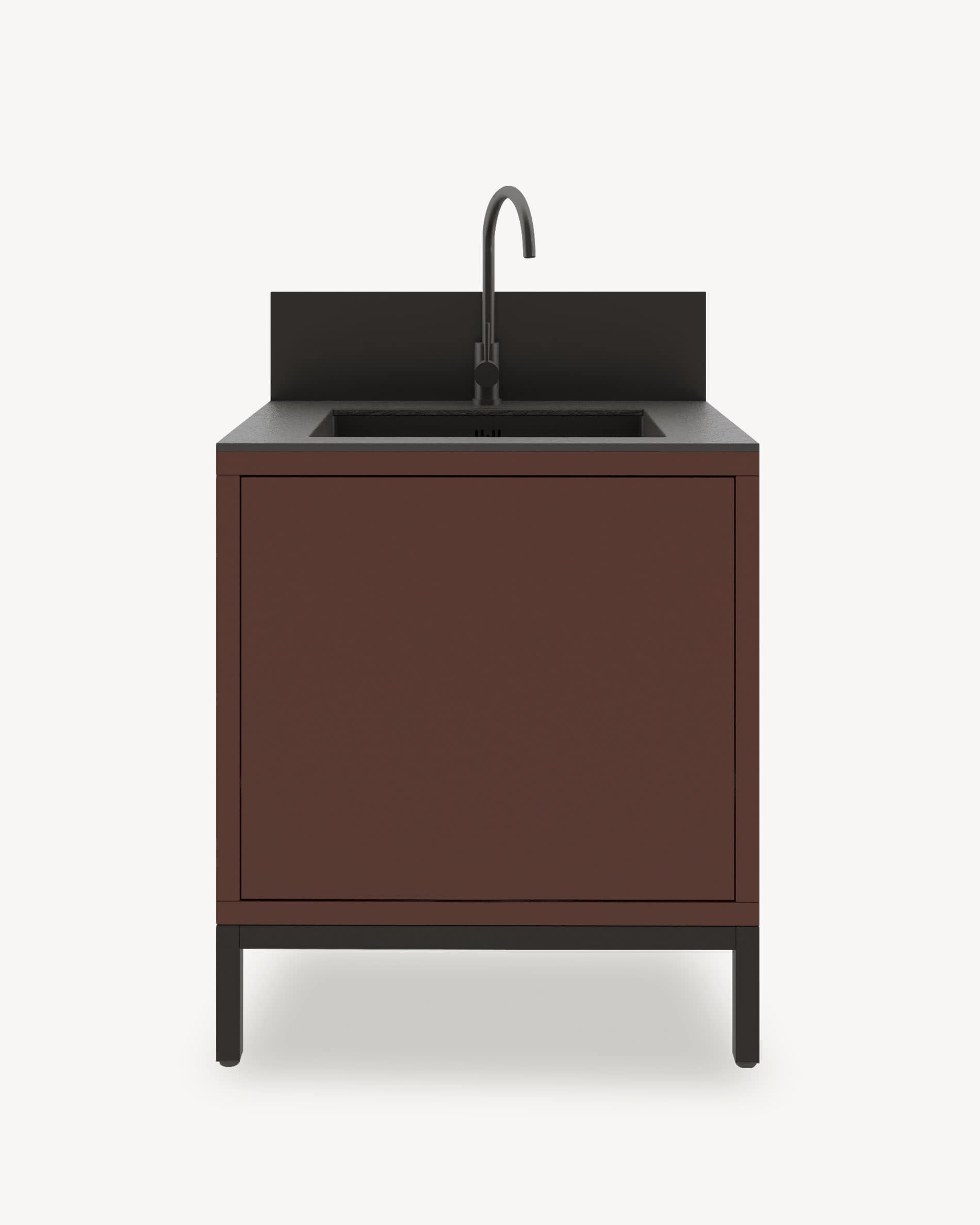 Module de cuisine pilotis avec évier intégré, meuble coloris brun rouille avec rangement fermé, plan de travail sombre et crédence intégrée.